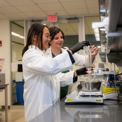 Graduate student assistant Stephanie Wong works in a UConn Health biomedical engineering laboratory as assistant professor Alix Deymier Ph.D. observes